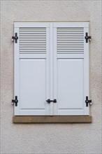 Windows with grey metal shutters