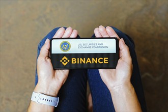 In this photo illustration, the Securities and Exchange Commission (SEC) and Binance logo is