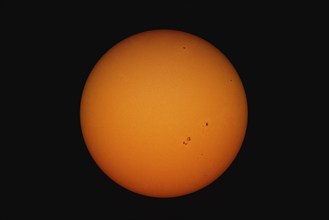 A view of the suns with spots and structure through a telescope