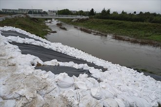 Reinforcement of river embankments with foil and sandbags, flood risk in Wroclaw, Poland, Europe