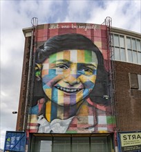 A picture of the Let Me Be Myself colorful mural, depicting Anne Frank, created by Eduardo Kobra in