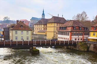 Bamberg city center street view with houses and bridge over the river