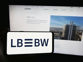 Stuttgart, Germany, 07-15-2024: Person holding smartphone with logo of German company Landesbank