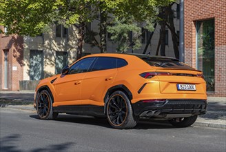 A picture of an orange Lamborghini Urus