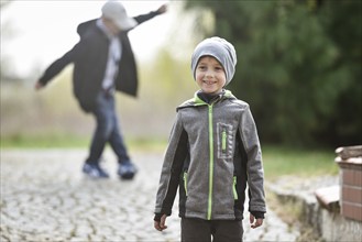 Smiling 6 years old boy playing aoutdoor