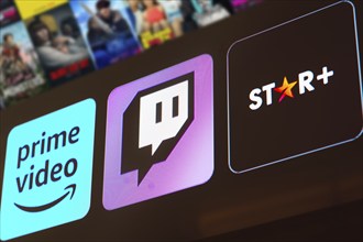 In this photo illustration the Amazon Prime Video, Twitch and Star Plus logo is displayed on a TV