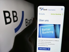 Stuttgart, Germany, 07-15-2024: Person holding cellphone with webpage of German financial services