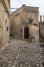 Ancient medieval alleyway somewhere in the historic town of Matera, Italy, Europe