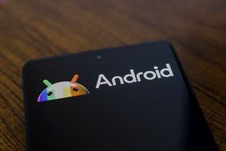 In this photo illustration, the Android logo is displayed on a smartphone screen