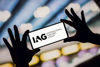 In this photo illustration, the International Airlines Group (IAG) logo is displayed on a