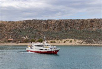 A picture of a ferry next to the Gramvousa Island