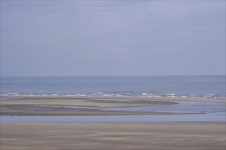 Sea with low tide on a sandy beach