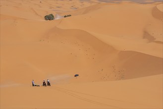 Motorbikers driving off-road in the Erg Chebbi desert near Merzouga, Morocco, Africa