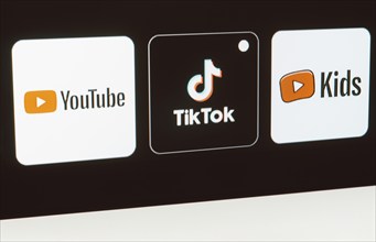 In this photo illustration the YouTube, TikTok, YouTube Kids logo is displayed on a TV screen