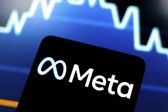 In this photo illustration, the Meta logo is displayed on a smartphone screen and in the