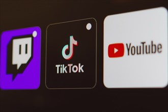 In this photo illustration the TikTok, Twitch and YouTube logo is displayed on a TV screen