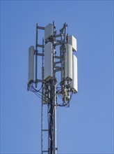 Multiple antennas and electronic equipment are installed on a telecommunication tower, enabling