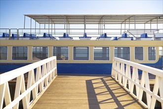 Passenger Ship and Boardwood walk bridge in Faro's Harbour, Portugal, Europe