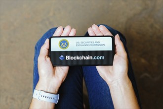 In this photo illustration, the Securities and Exchange Commission (SEC) and Blockchain.com logo is