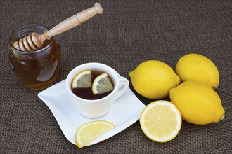 Cup of tea with honey and lemon. Spicy medicinal tea for autumn-winter season