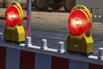 Roadworks with barriers and warning lights at night