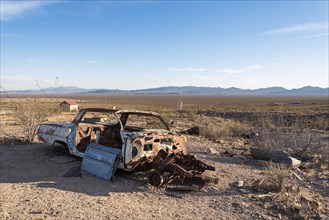 Abandoned car wreck in the ghost town Rhyolite in the Death Valley, USA, North America