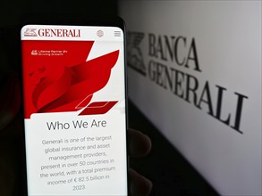 Stuttgart, Germany, 06-01-2024: Person holding smartphone with web page of Italian financial