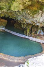 Amazing blue turquoise water and limestone cave sinkhole cenote at Santuario de los guerreros in