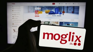 Stuttgart, Germany, 07-11-2024: Person holding smartphone with logo of e-commerce company Mogli