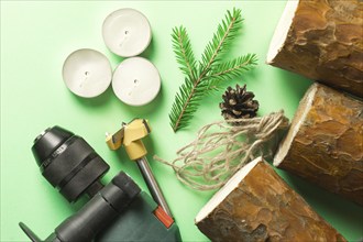 DIY Christmas candle holder made of pine logs, candles, craft rope, fir branches and cones. Layout