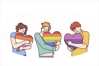 People hugging hearts painted in colors of LGBT and LGBTQ flags making freedom of choice in sex and