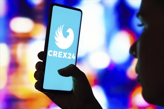 In this photo illustration, the Crex24 Exchange logo seen displayed on a smartphone