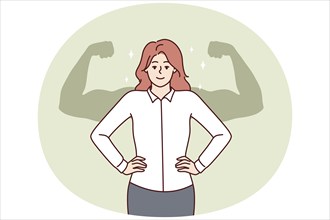 Successful businesswoman stands with hands on waist imagining giant muscular arms behind back.