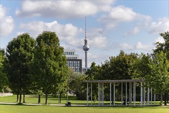 A picture of the Berlin television tower as seen from the Spreebogenpark