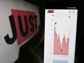 Stuttgart, Germany, 03-23-2024: Person holding cellphone with website of British financial services