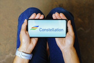 In this photo illustration, the Constellation Energy Corporation logo is displayed on a smartphone