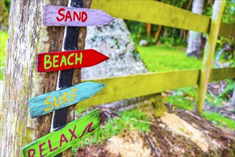 Sand beach surf and relax on colorful directional wooden arrows on the Mangrove beach and Pouso