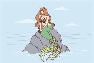 Mermaid sits on sea rock to illustrate fairy tales about ocean dwellers and magical creatures