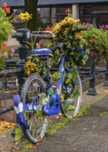 A picture of a colorful bicycle decorated with flowers in Amsterdam