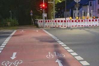 Roadworks with barriers and warning lights at night