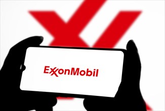 ExxonMobil Corporation Logo on a mobile screen stock image. It's a major multinational publicly