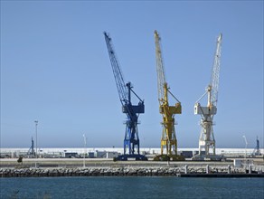 Three colorful dock cranes in the harbor of Tangier, Morocco, Africa