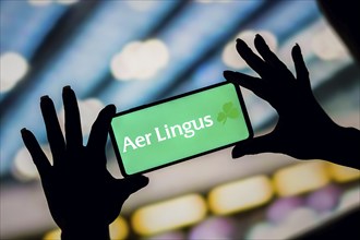 In this photo illustration, the Aer Lingus logo is displayed on a smartphone screen