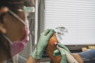 Podiatric foot treatment, milling of the epidermis with a tool. A close-up of the treatment. Close