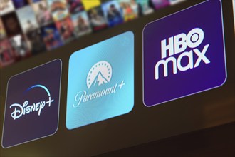 In this photo illustration the Disney Plus, Paramount Plus and HBO Max logo is displayed on a TV