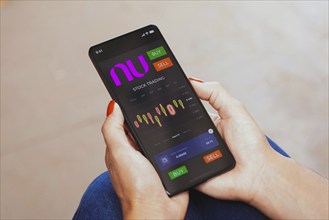 In this photo illustration, the stock trading graph of Nubank seen on a smartphone screen