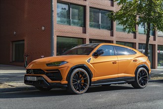 A picture of an orange Lamborghini Urus