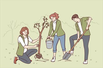 Volunteers plant trees in park and water seedlings to save nature from co2 emissions and climate