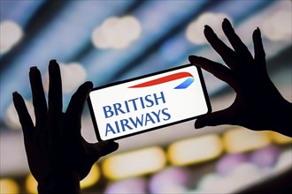 In this photo illustration, the British Airways logo is displayed on a smartphone screen