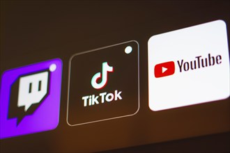 In this photo illustration the TikTok, Twitch and YouTube logo is displayed on a TV screen